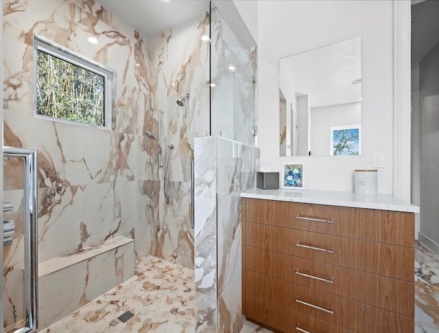 bathroom with vanity and a marble finish shower