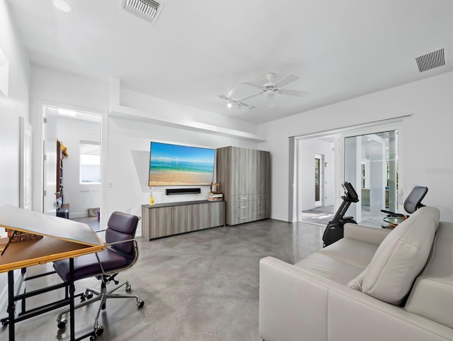 interior space with finished concrete flooring, visible vents, and a ceiling fan