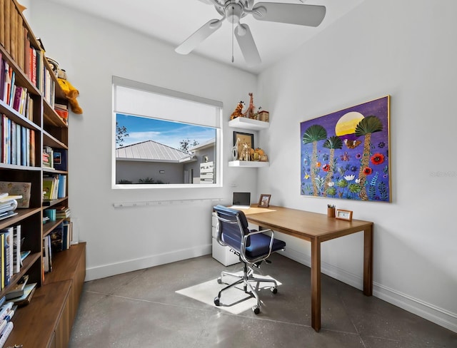 office space with a ceiling fan, finished concrete flooring, and baseboards