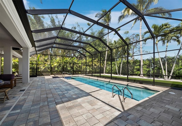 outdoor pool with a lanai and a patio