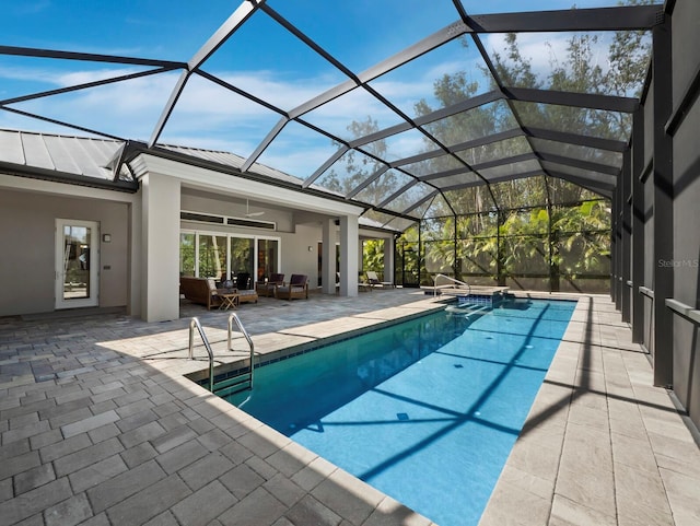 pool with ceiling fan, glass enclosure, outdoor lounge area, and a patio area