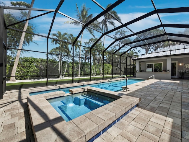 view of swimming pool featuring a lanai, a pool with connected hot tub, and a patio