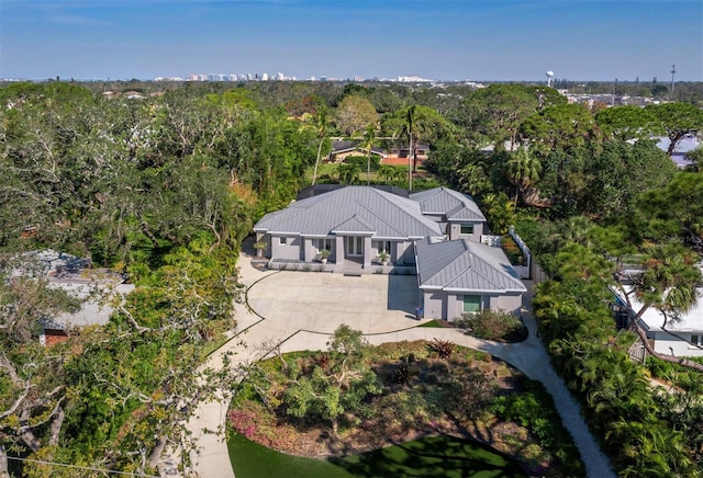 birds eye view of property with a view of trees