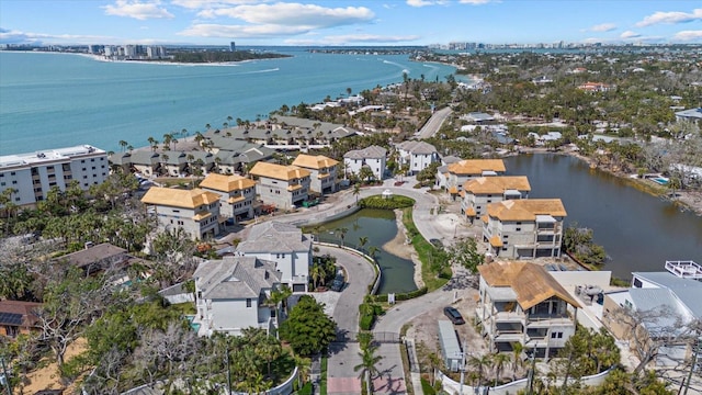 view of property location with a large body of water and nearby suburban area