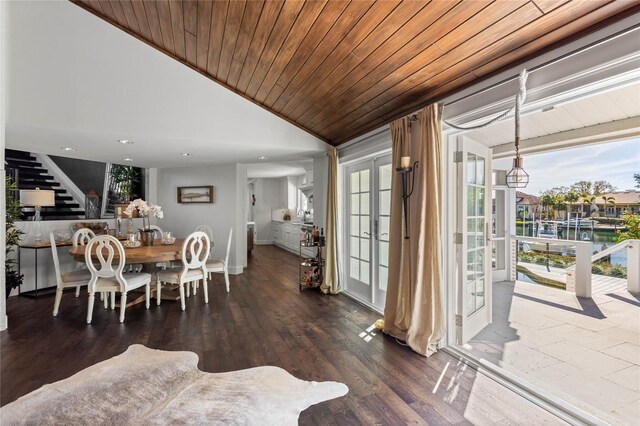 dining area with stairway, wood finished floors, lofted ceiling, french doors, and wooden ceiling