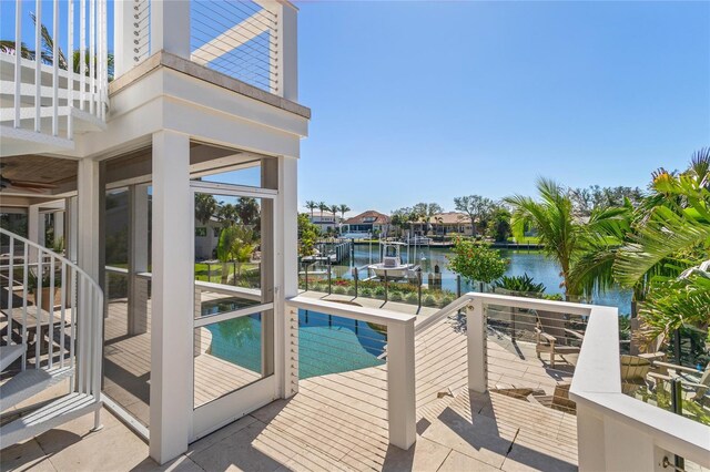 outdoor pool featuring a water view and a patio area