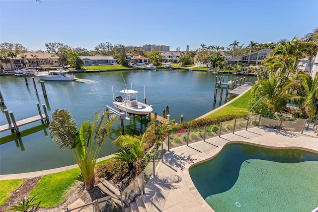 exterior space featuring fence, a dock, a residential view, and boat lift