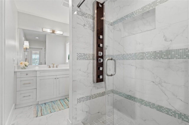 bathroom featuring a marble finish shower, marble finish floor, and vanity