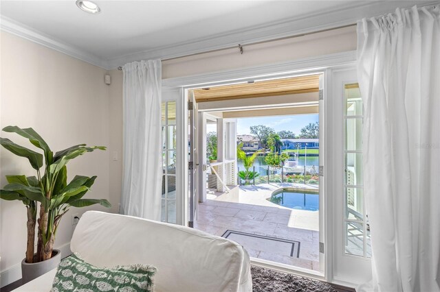 bedroom with crown molding and access to outside