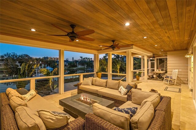 view of patio featuring an outdoor living space with a fire pit and a ceiling fan