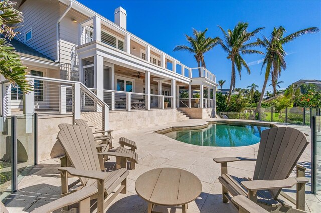 view of pool with a patio area, a fenced in pool, stairs, and ceiling fan