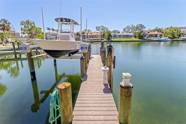 dock area featuring a water view, a residential view, and boat lift