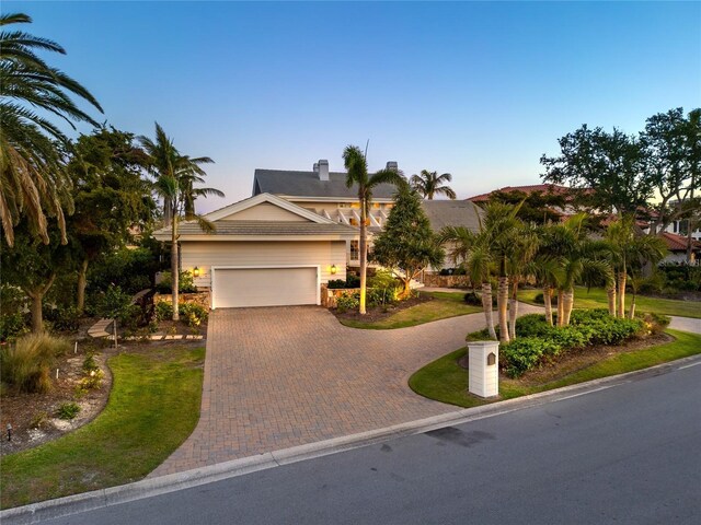 view of front facade with decorative driveway and a garage