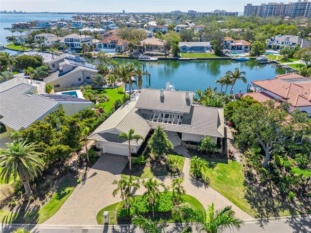 drone / aerial view with a residential view and a water view