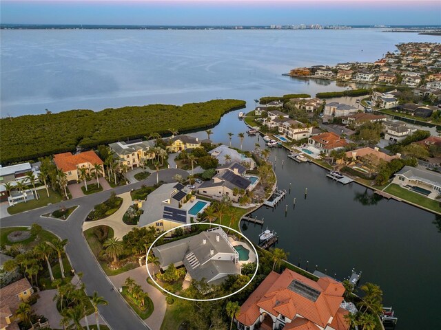 drone / aerial view with a residential view and a water view