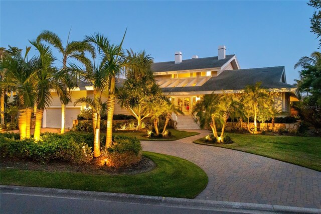 view of front of home with a front lawn and curved driveway