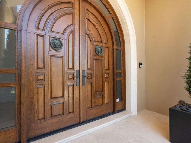 doorway to property featuring stucco siding