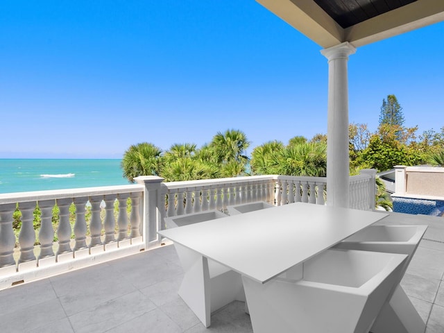 view of patio / terrace with outdoor dining space and a water view