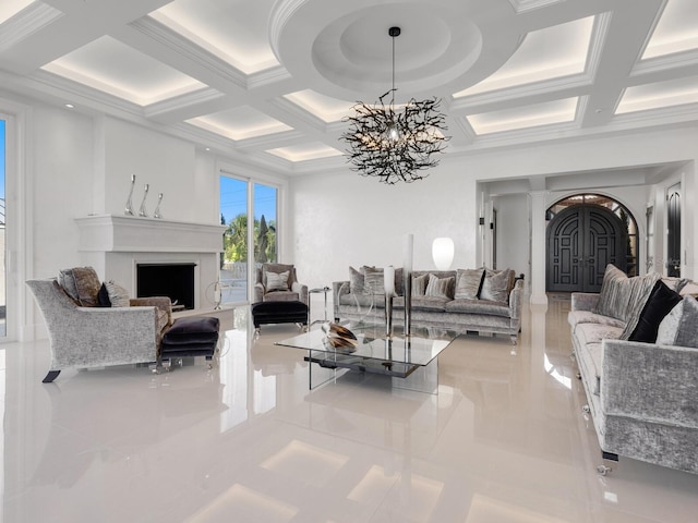 living area with arched walkways, a notable chandelier, a fireplace, and coffered ceiling