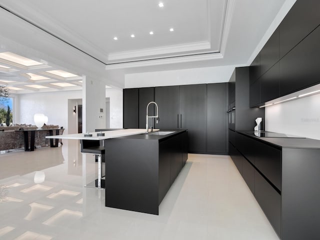 kitchen featuring a sink, black electric stovetop, modern cabinets, and dark cabinetry