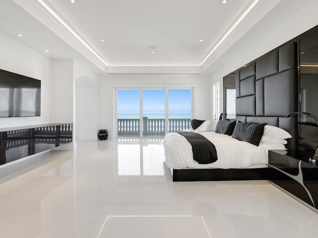 bedroom with access to exterior, a raised ceiling, crown molding, and a water view