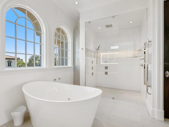 bathroom with visible vents, walk in shower, a freestanding bath, ornamental molding, and tile patterned floors