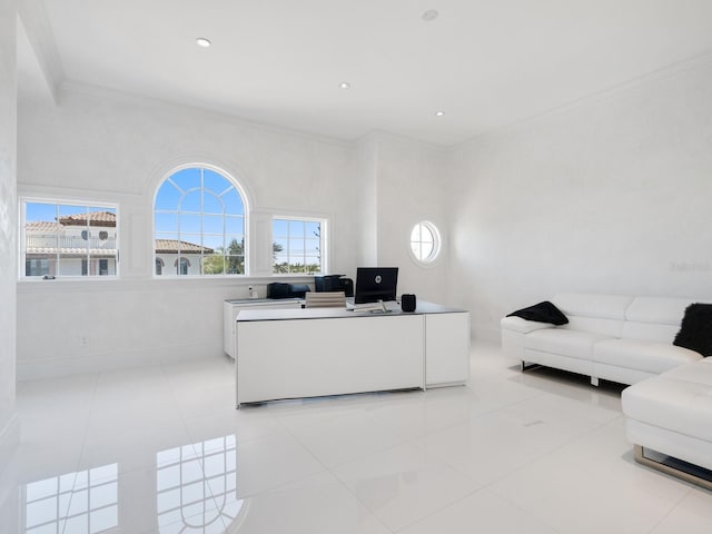 office space with light tile patterned floors, plenty of natural light, crown molding, and baseboards