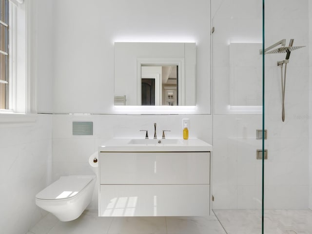 bathroom with a shower stall, tile walls, vanity, and toilet