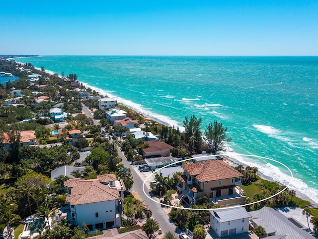 bird's eye view featuring a view of the beach and a water view