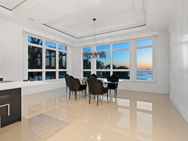 sunroom / solarium with a raised ceiling and a notable chandelier