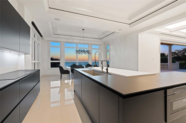 3909 Casey Key Rd, Nokomis, FL 34275 - kitchen featuring a raised ceiling, a kitchen island with sink, modern cabinets, and crown molding