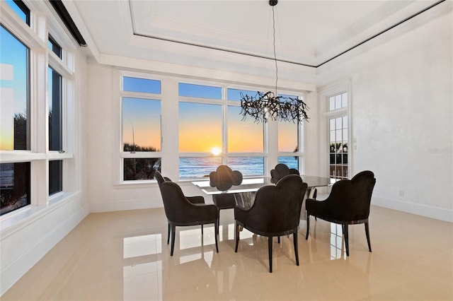 3909 Casey Key Rd, Nokomis, FL 34275 - dining space with ornamental molding, a chandelier, a water view, a raised ceiling, and baseboards