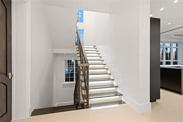 3909 Casey Key Rd, Nokomis, FL 34275 - stairway featuring baseboards, recessed lighting, and a high ceiling