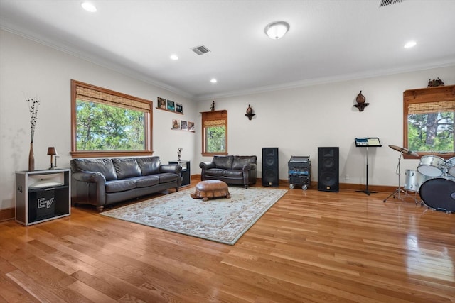 living area with crown molding, recessed lighting, visible vents, wood finished floors, and baseboards