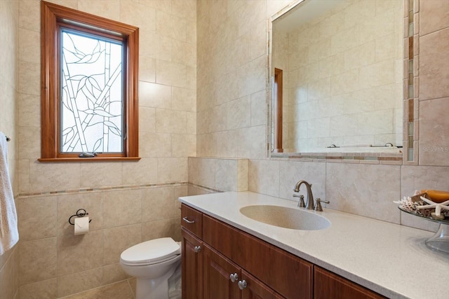 bathroom with decorative backsplash, tile walls, vanity, and toilet