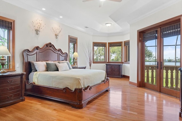 bedroom featuring access to exterior, light wood finished floors, baseboards, and crown molding