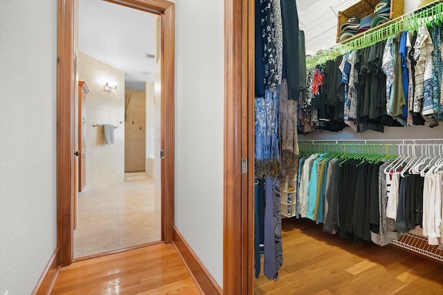 spacious closet with wood finished floors