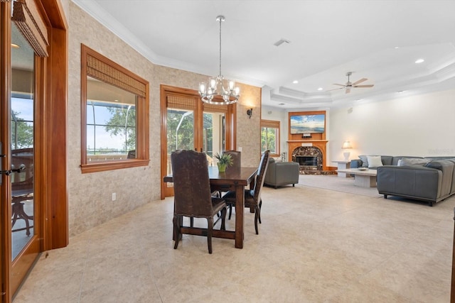 dining room featuring recessed lighting, a raised ceiling, visible vents, ornamental molding, and a glass covered fireplace