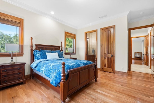 bedroom with crown molding, light wood-style flooring, and baseboards