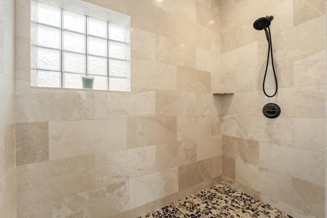 full bath featuring a tile shower