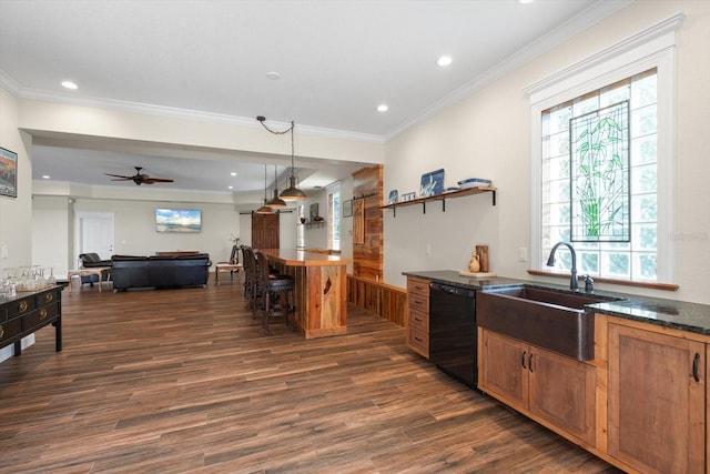 kitchen featuring a breakfast bar, black dishwasher, crown molding, dark wood-type flooring, and a sink