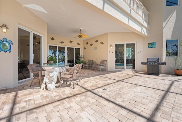 view of patio / terrace featuring a grill, outdoor dining area, and a ceiling fan