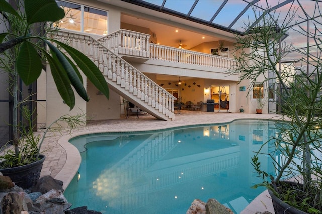 pool featuring stairs, a patio, and a lanai