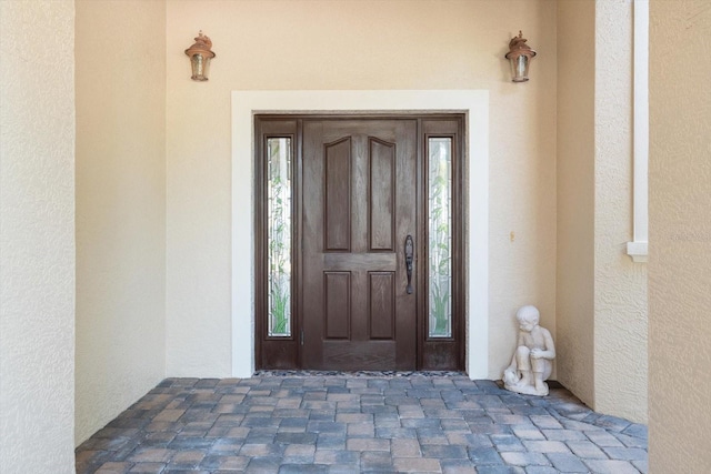 doorway to property with stucco siding