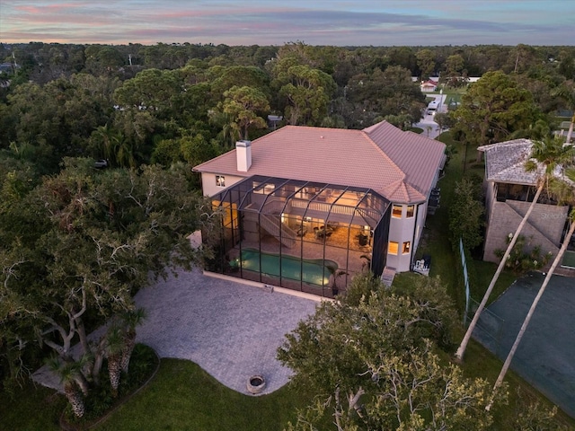 aerial view at dusk with a view of trees