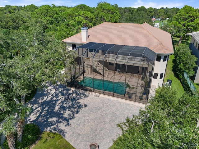 birds eye view of property with a view of trees