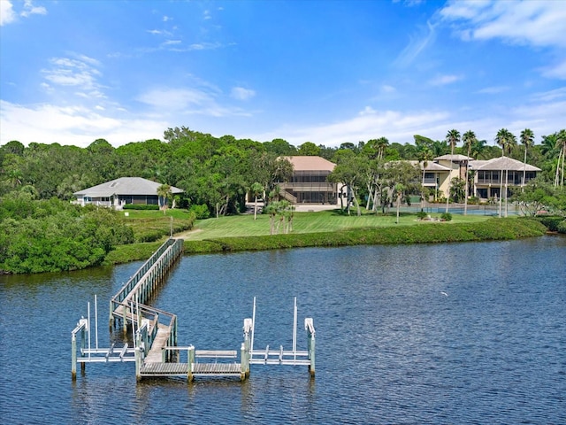 view of dock featuring a water view, boat lift, and a yard