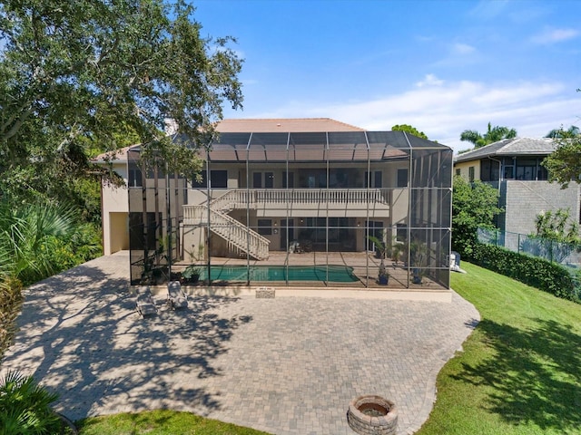 view of home's community with a patio area, stairway, a pool, and a yard