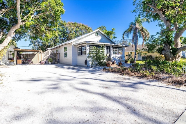 single story home with driveway and an attached carport