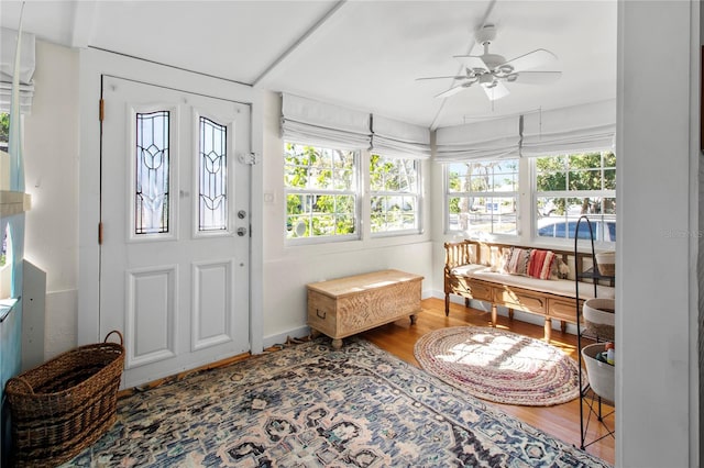 foyer with ceiling fan, baseboards, and wood finished floors